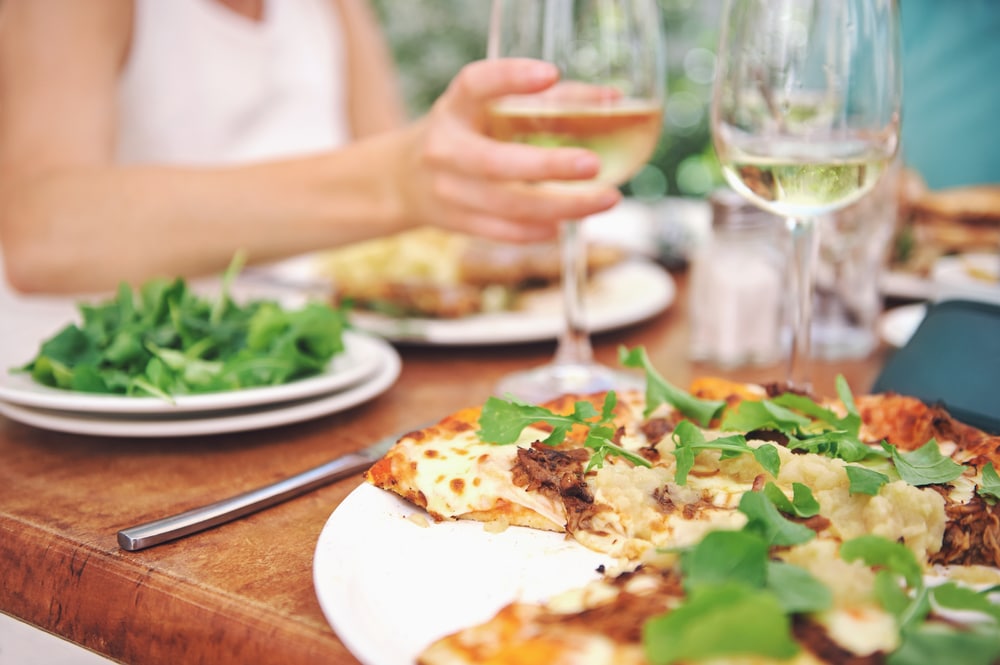 Restaurants in McMinnville, photo of a casual lunch with pizza and Oregon white wine