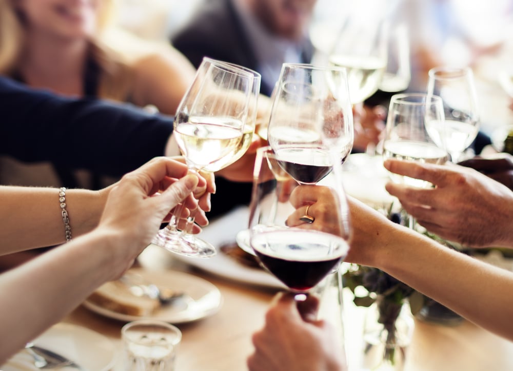 Group of friends toasting wine glasses in Downtown McMinnville restaurant