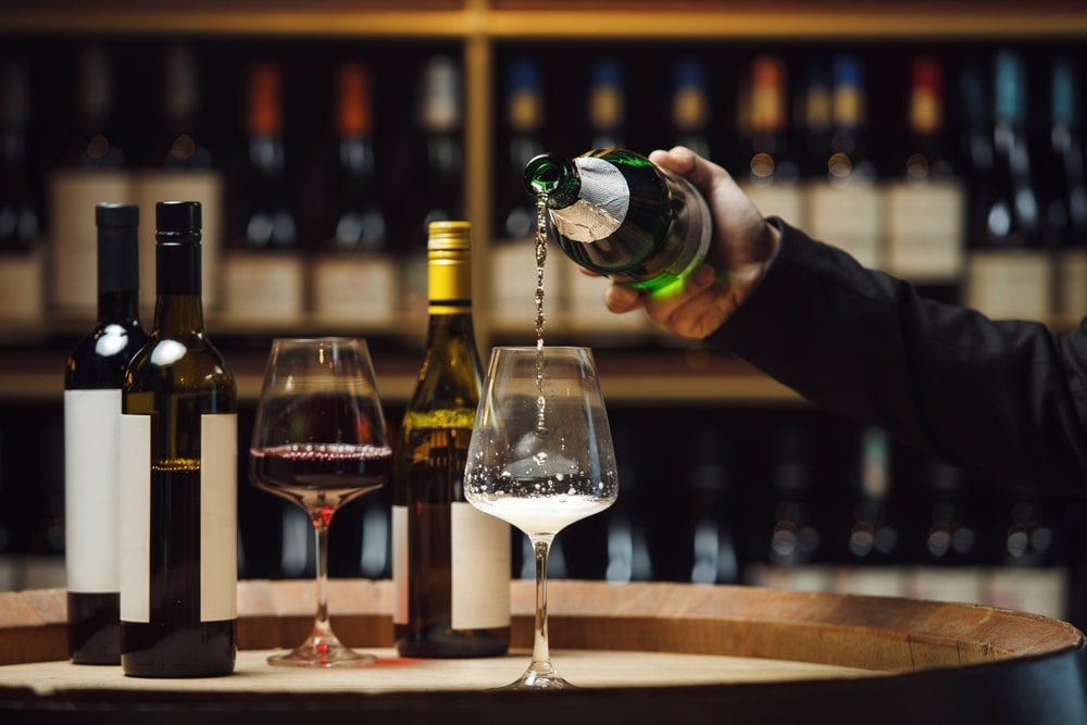 Sommelier pouring a glass of Oregon Sparkling wine and Willamette Valley Pinot Noir